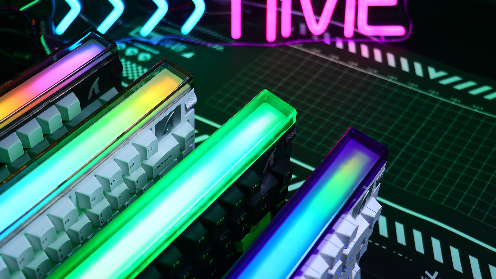 Row of mechanical keyboards featuring bright, multi-colored LED light bars and neon accents.