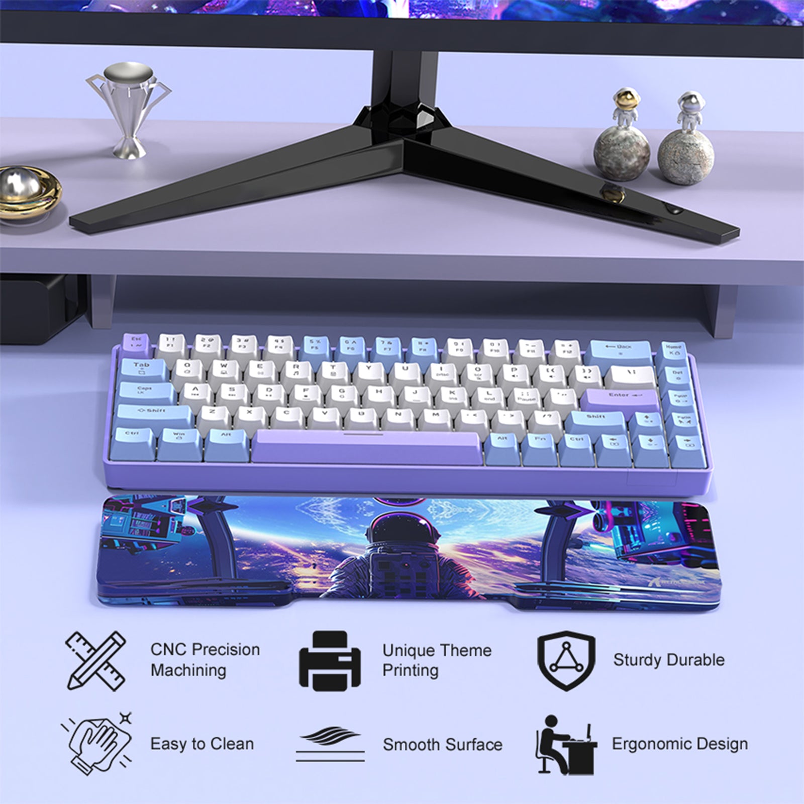 Astronaut acrylic wrist rest with vibrant space design next to a colorful mechanical keyboard.