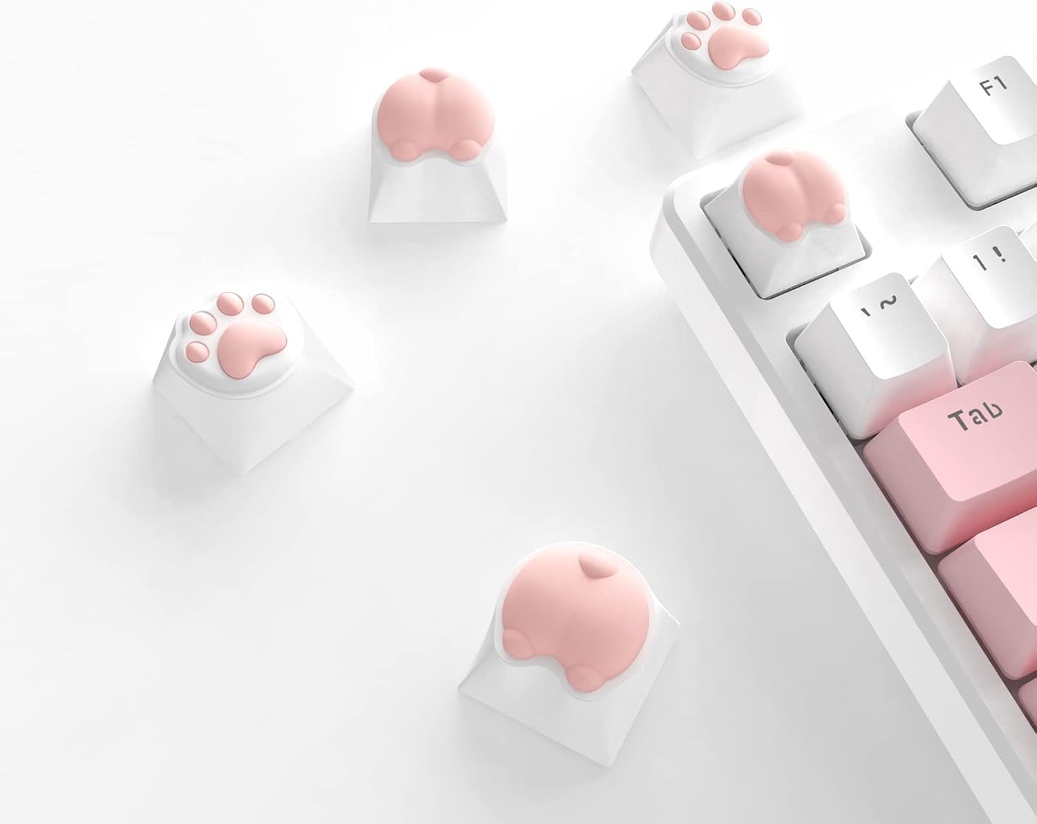 Cute cat paws and butts keycaps in pink on white mechanical keyboard.