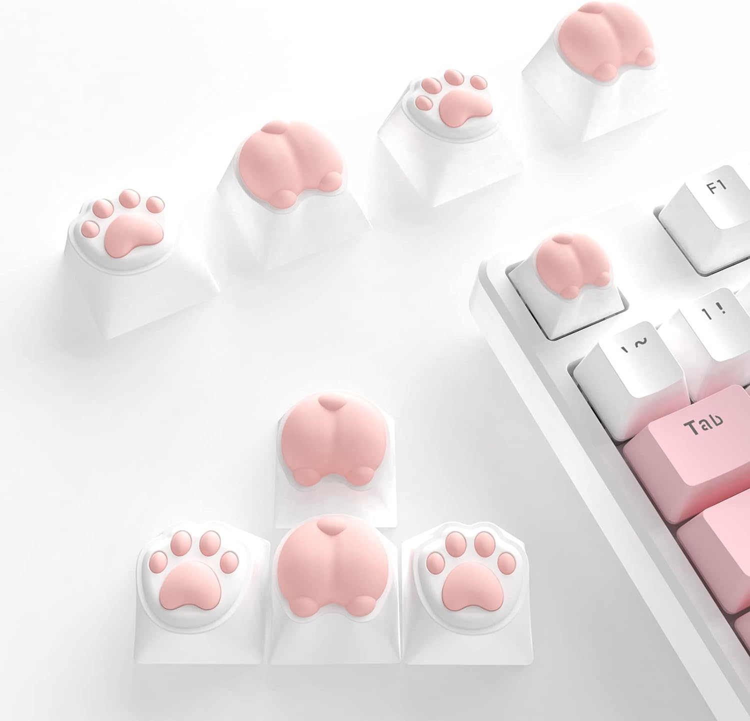 Pink cat paws and butts keycaps on white mechanical keyboard keys.