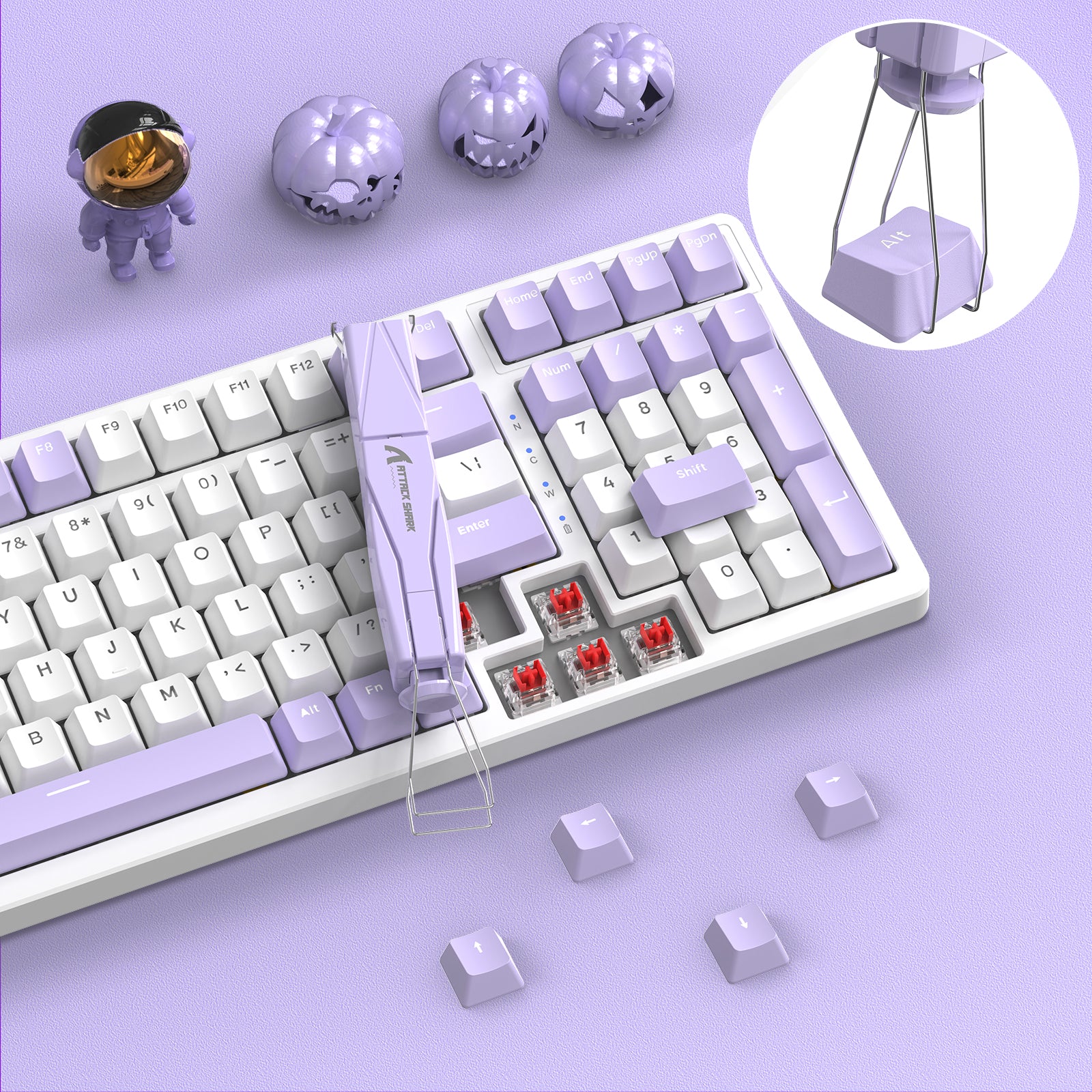 Lavender Attack Shark keycap and switch puller removing keycaps from mechanical keyboard.