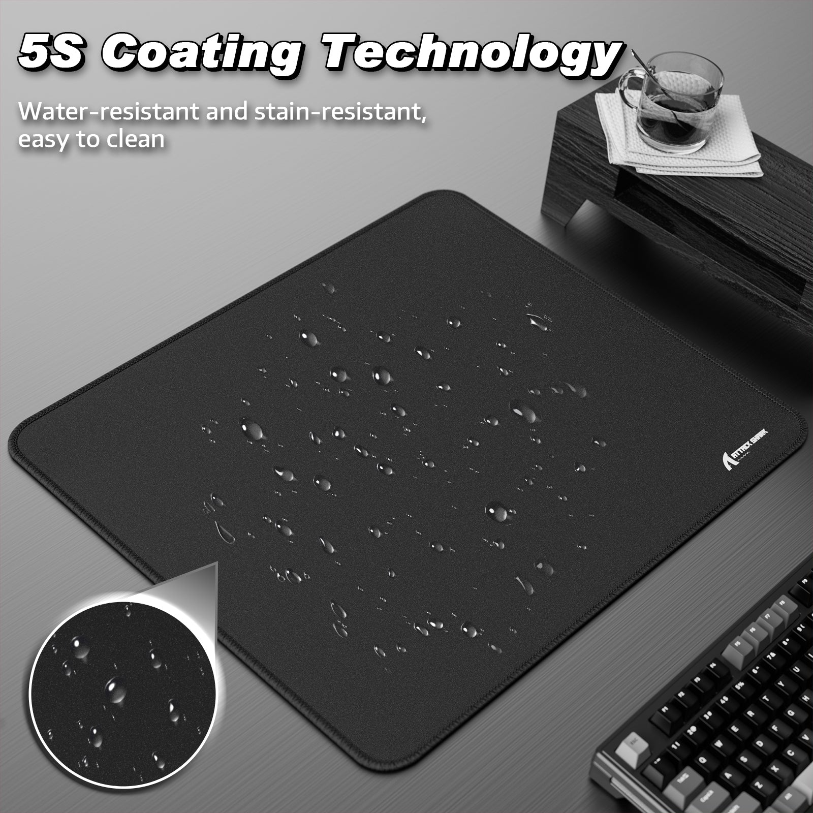 Black Attack Shark mouse pad with 5S water-resistant coating and liquid droplets.