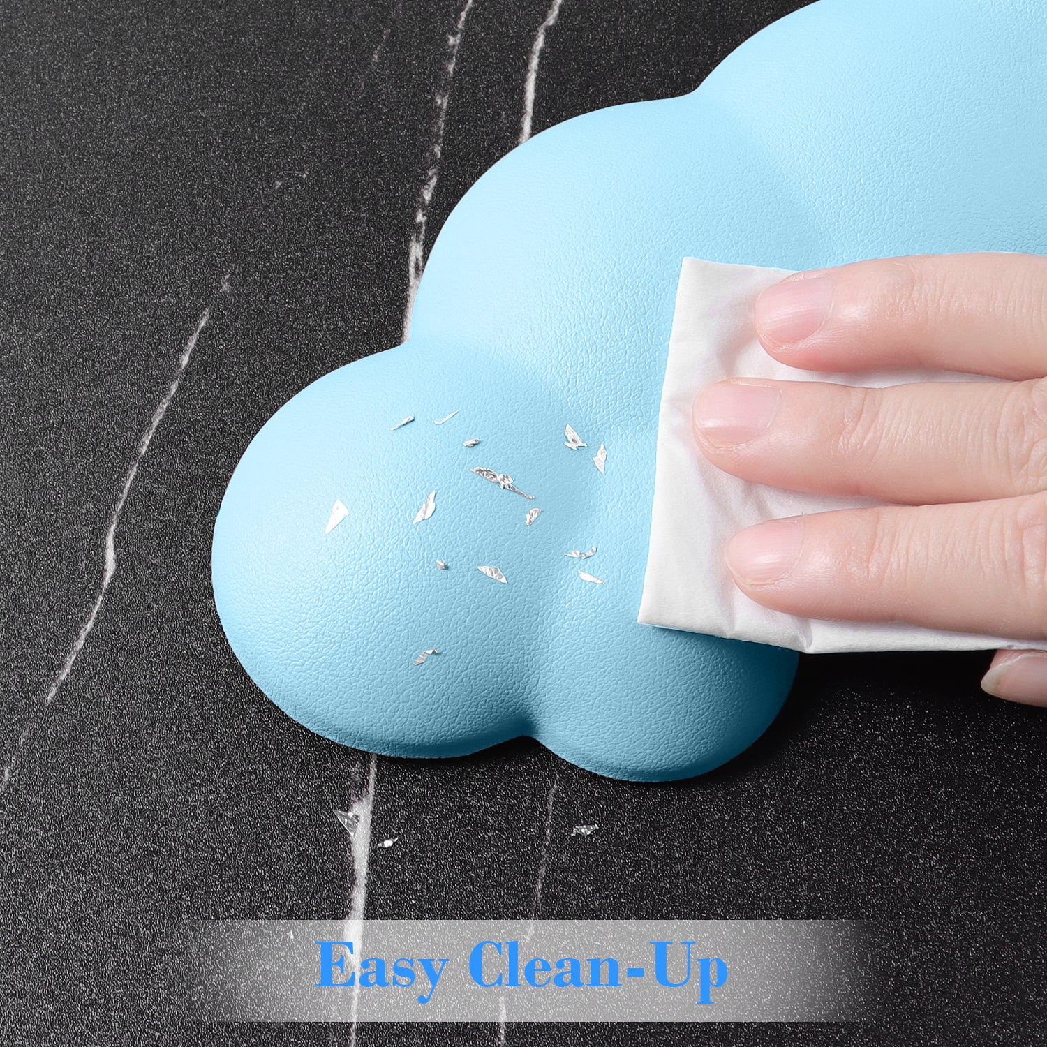 Hand wiping blue cloud-shaped wrist rest, showing easy clean-up surface.