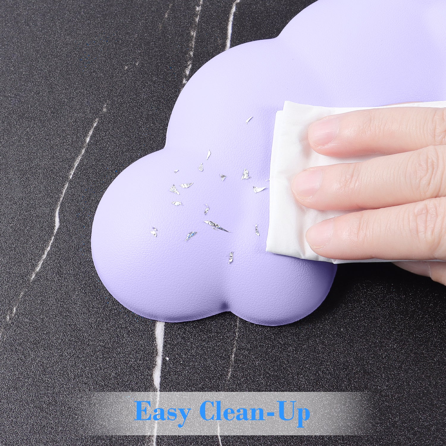 Hand wiping lavender cloud-shaped wrist rest for easy cleaning.