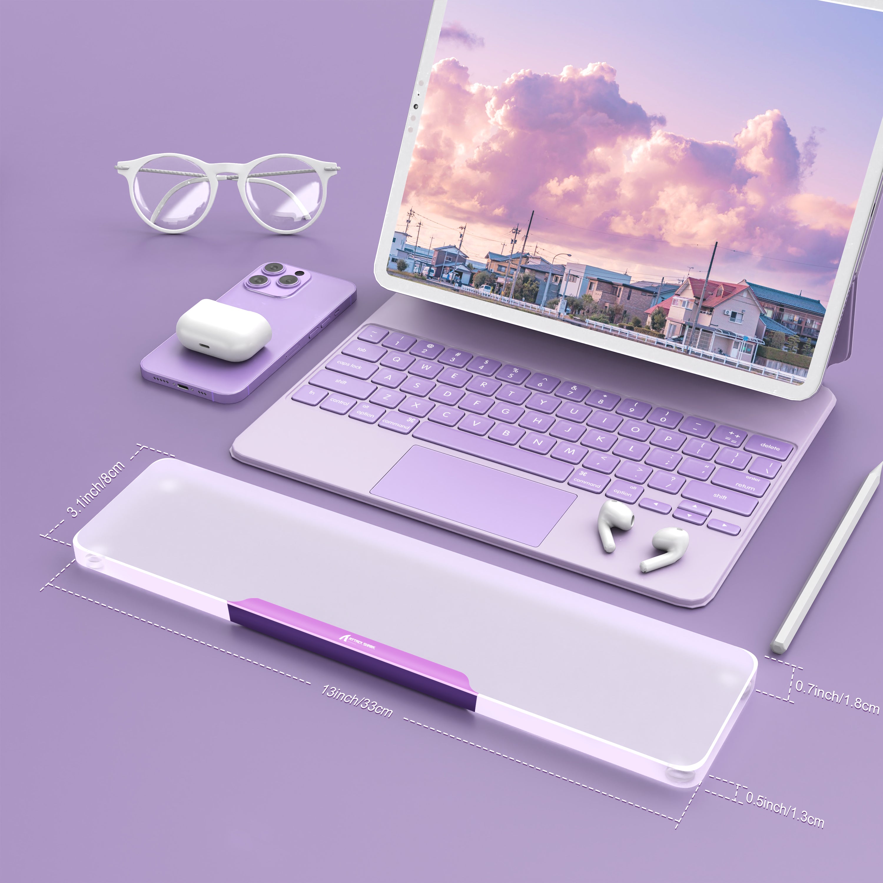 Translucent acrylic wrist rest in purple contrasted with keyboard and laptop on a purple desk.