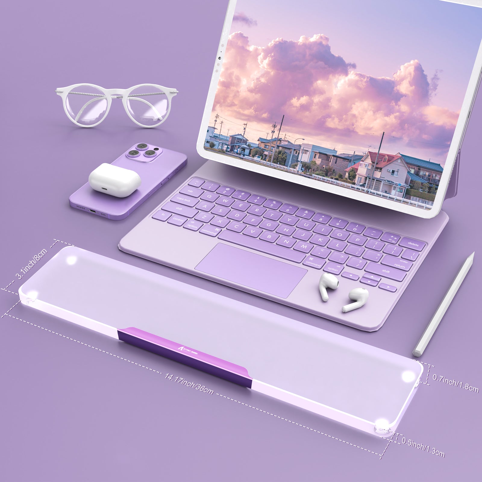 Purple translucent acrylic wrist rest next to laptop and wireless accessories on stylish workspace.