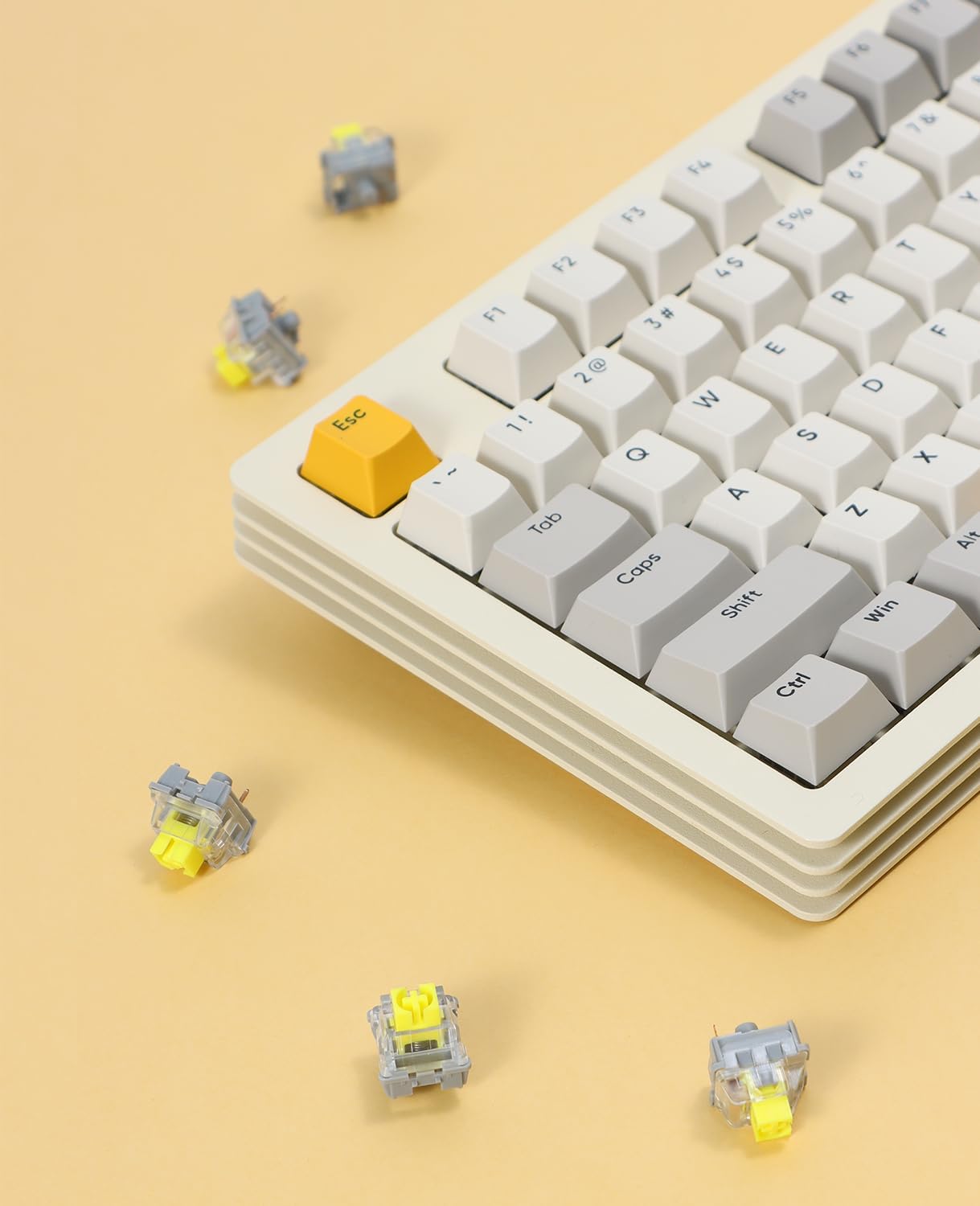 Mechanical keyboard with blue keycaps and yellow AS switches scattered around.