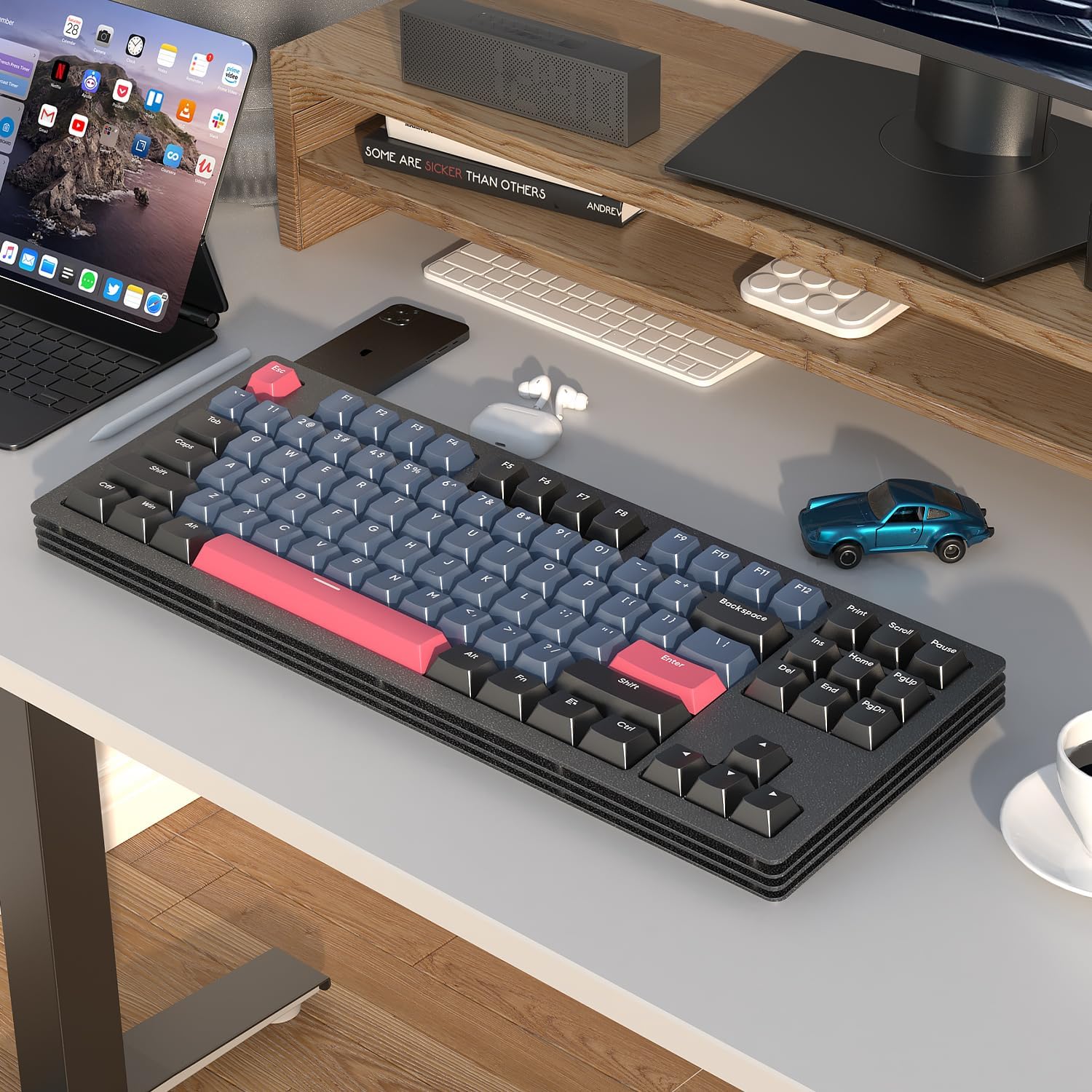 AJAZZ AKC087 keyboard with blue-gray and pink keycaps on a modern workspace.