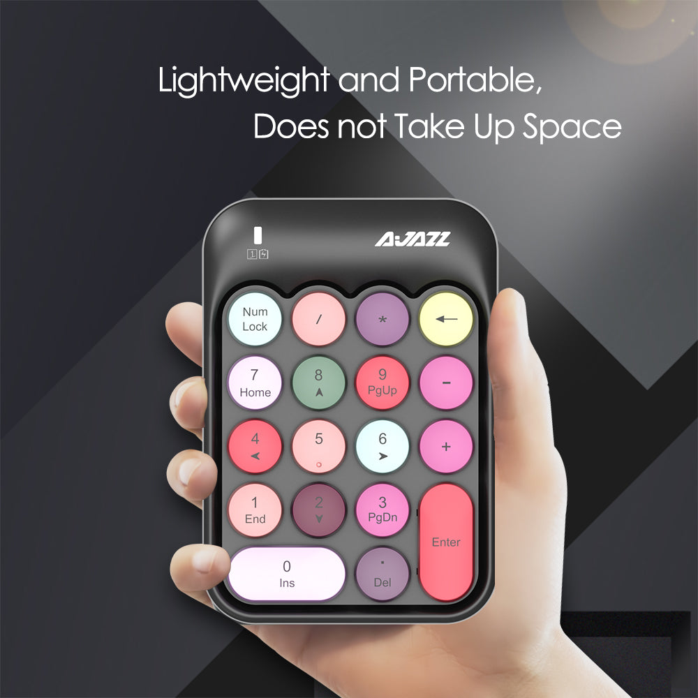 Hand holding AJAZZ AK18 pastel wireless numeric keypad, emphasizing portability and compact size.