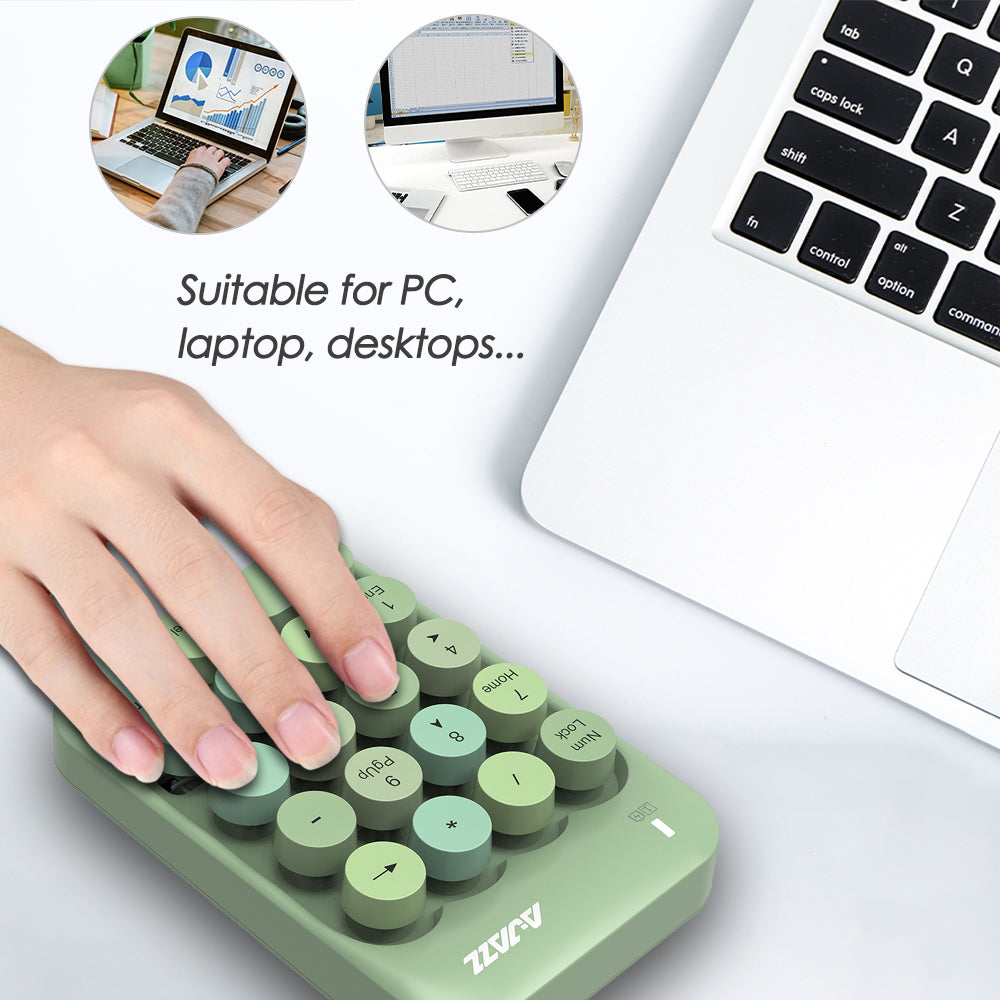 Light green wireless numeric keypad in use beside a laptop, ideal for PC and desktop tasks.