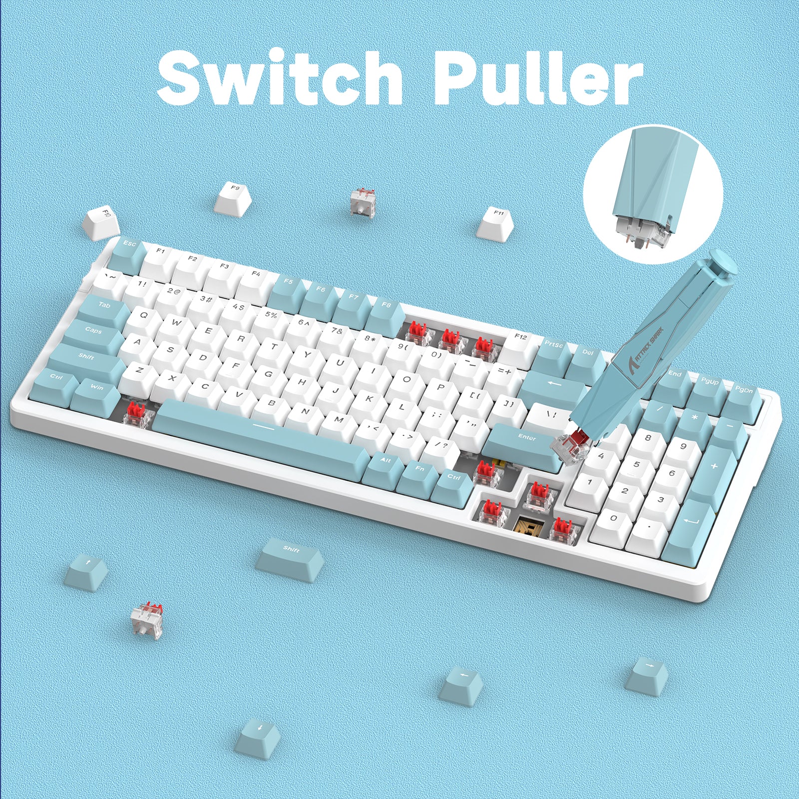 Attack Shark switch puller in use on light blue mechanical keyboard, keycaps scattered.