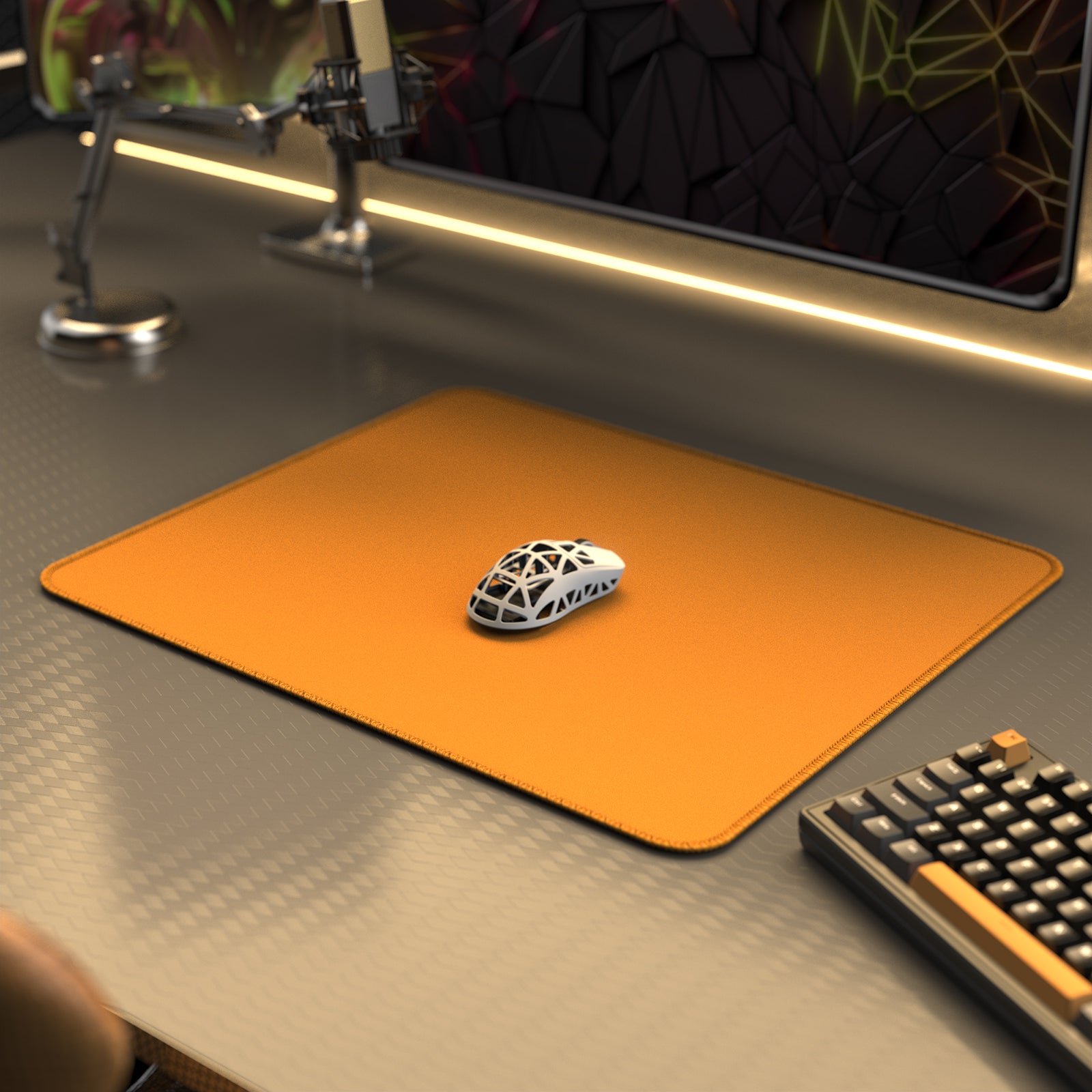 Orange Attack Shark gaming mouse pad enhancing mouse glide with gaming mouse on top.