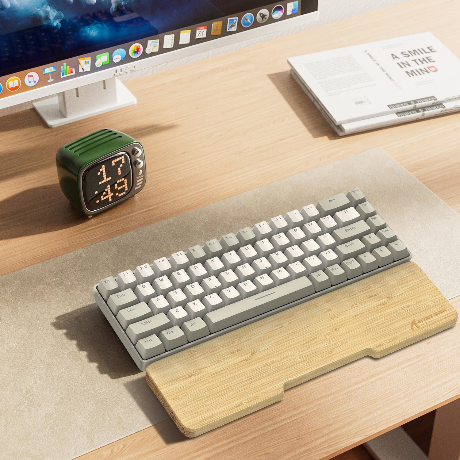 Bamboo wrist rest with compact beige-gray mechanical keyboard on wooden desk.