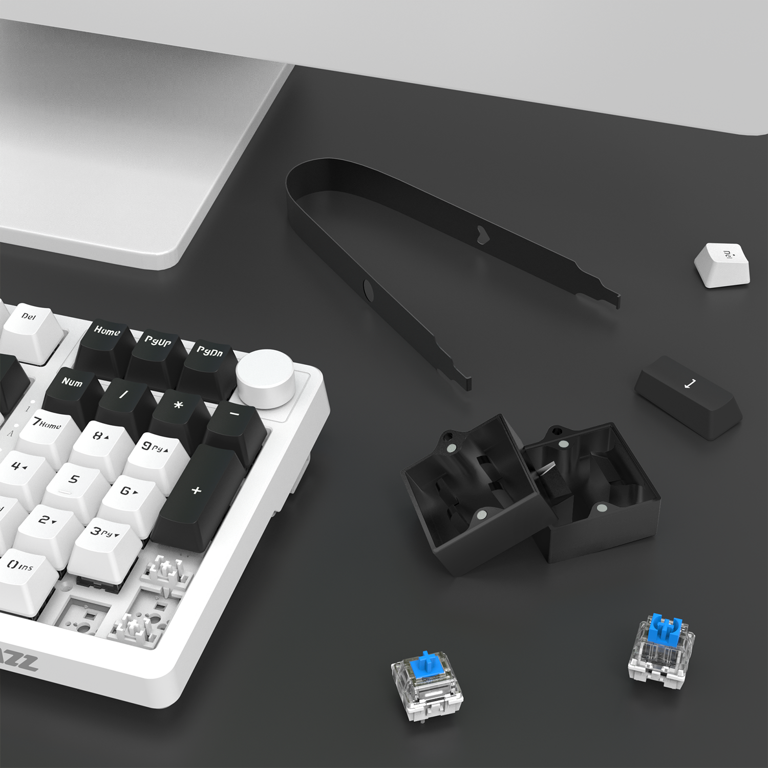 Switch opener kit components for mechanical keyboard customization on desk.