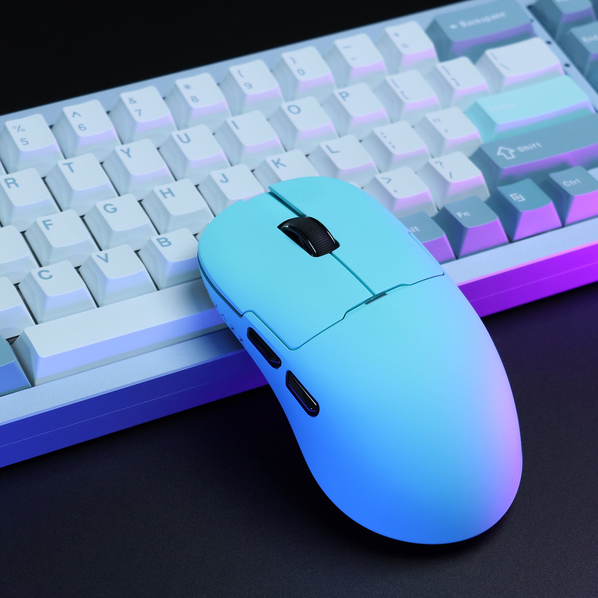 Gradient blue AJAZZ AJ159 APEX mouse next to RGB keyboard.